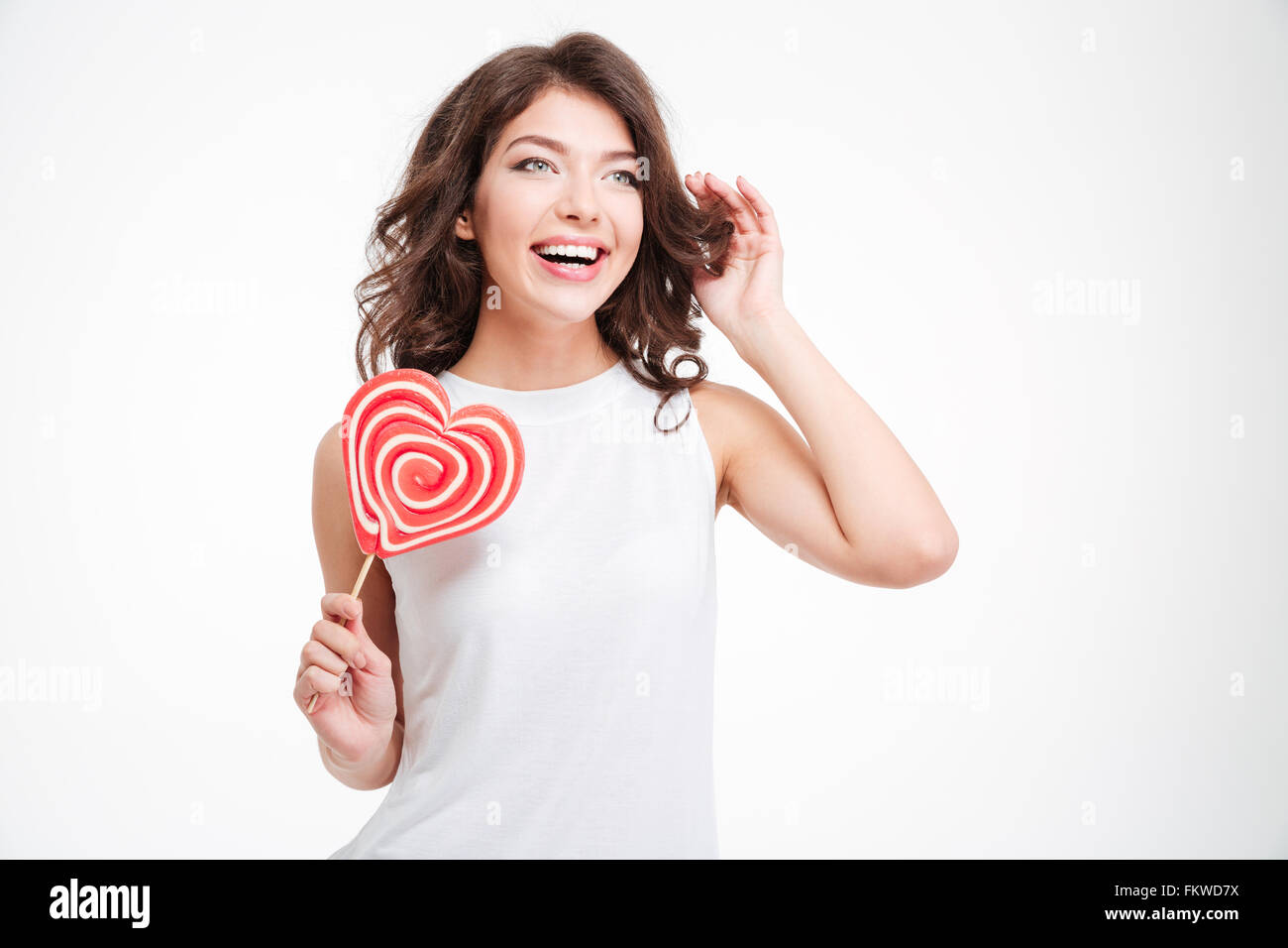 Junge Frau mit Lolli isoliert auf einem weißen Hintergrund lachen Stockfoto