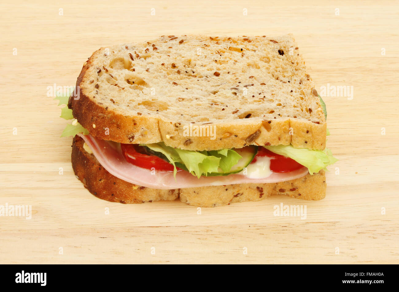 Schwarzbrot-Schinken und Salat-Sandwich auf ein Schneidbrett aus Holz Stockfoto