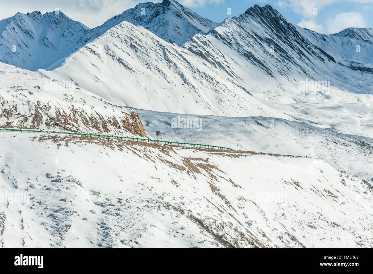 Straße in die schneebedeckten Berge Stockfoto