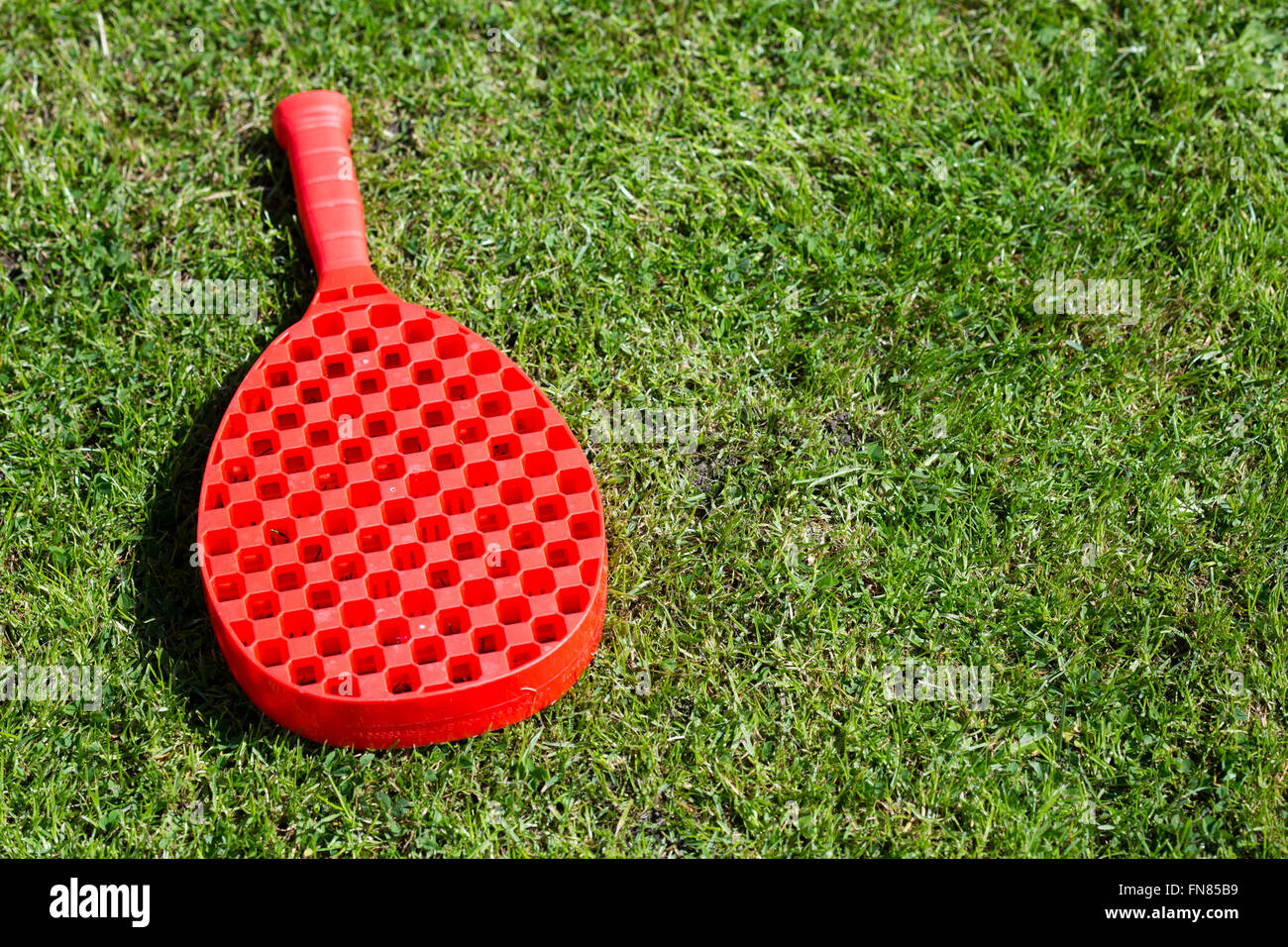 Roten Swingball Raquet auf dem Rasen liegen. Stockfoto