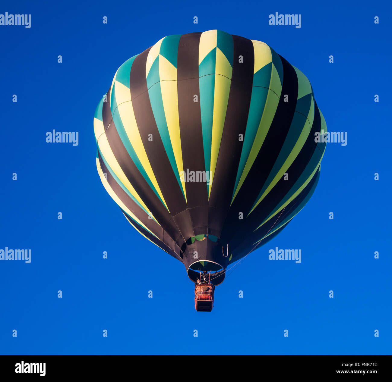 Ein Heißluftballon nur nach dem Start vor einem tiefblauen Himmel Stockfoto