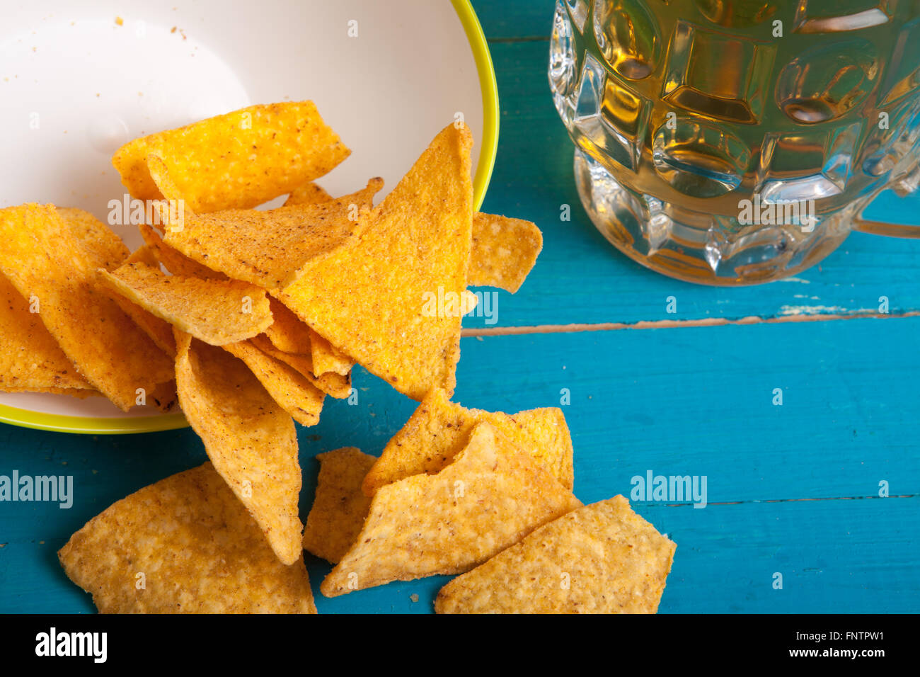 Mais-Chips und einem Krug Bier auf dem Tisch Stockfoto
