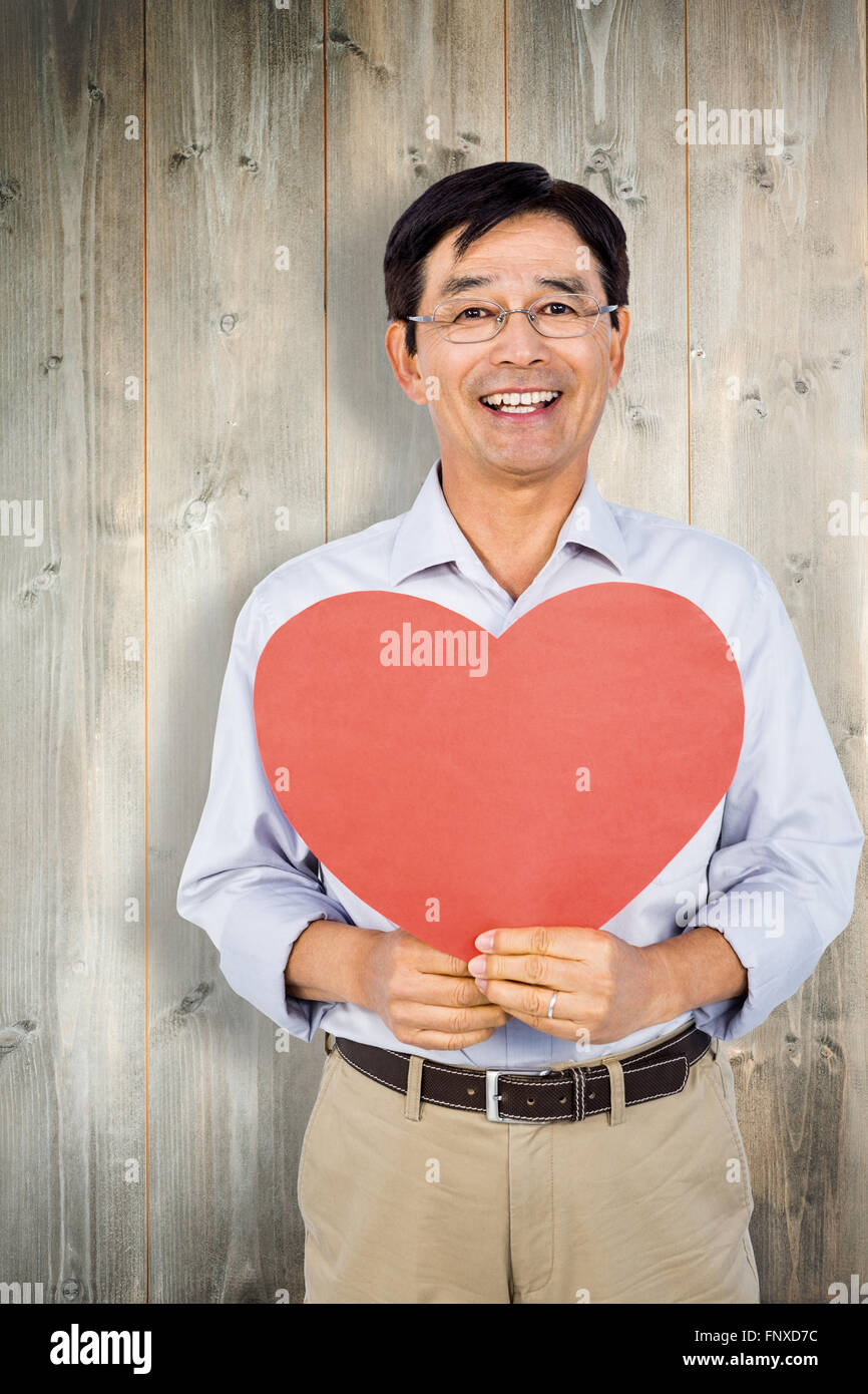 Zusammengesetztes Bild der älteren asiatischen Mann zeigt Herz Stockfoto