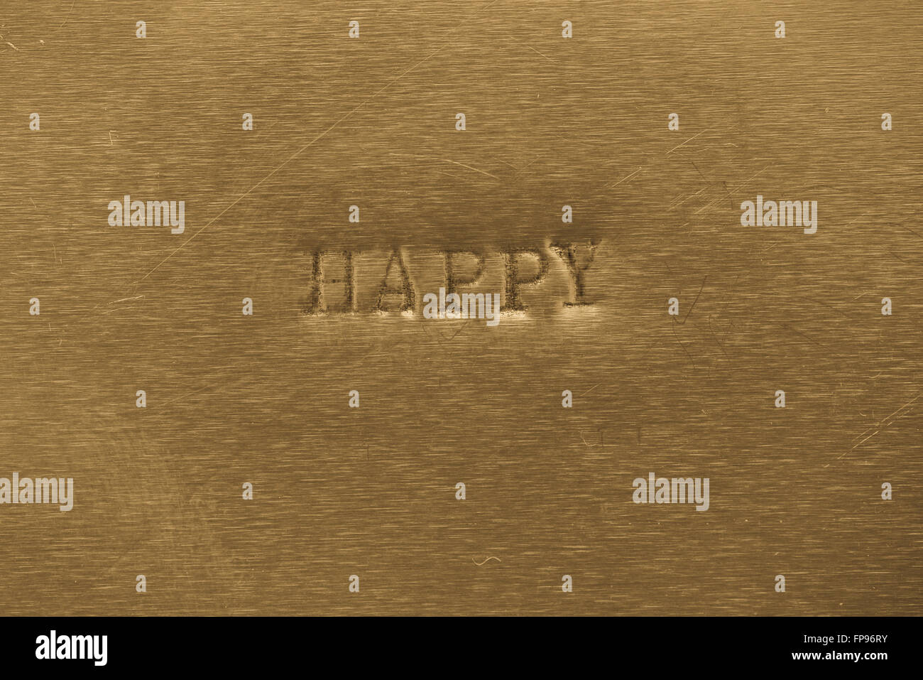 Wort glücklich auf Goldgrund metallic gedruckt Stockfoto