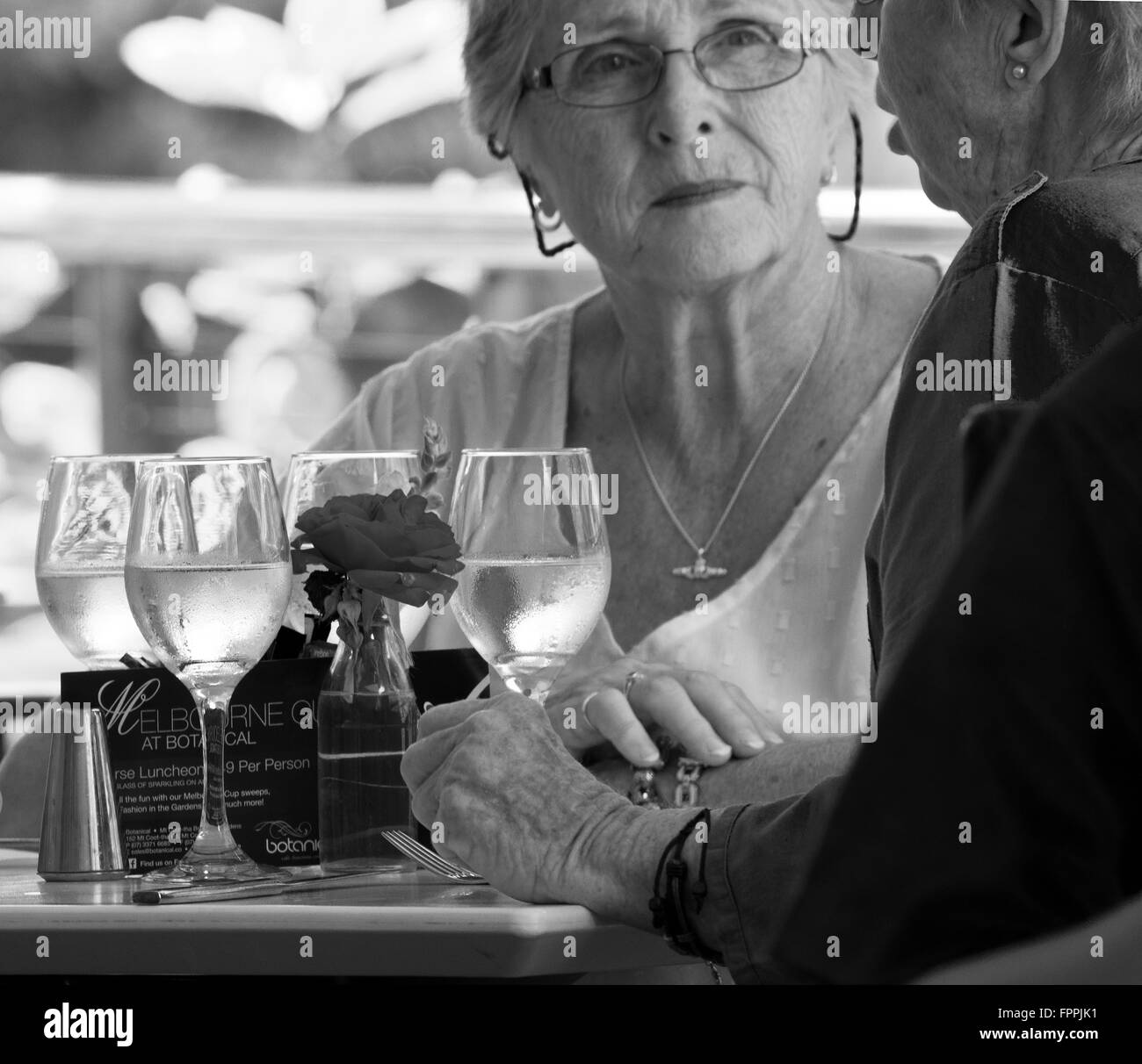 Senioren, Rentner Freundinnen nehmen alle Mittagessen gemeinsam bei einem Glas Wein Brisbane, Queensland, Autralia unter freiem Himmel Stockfoto