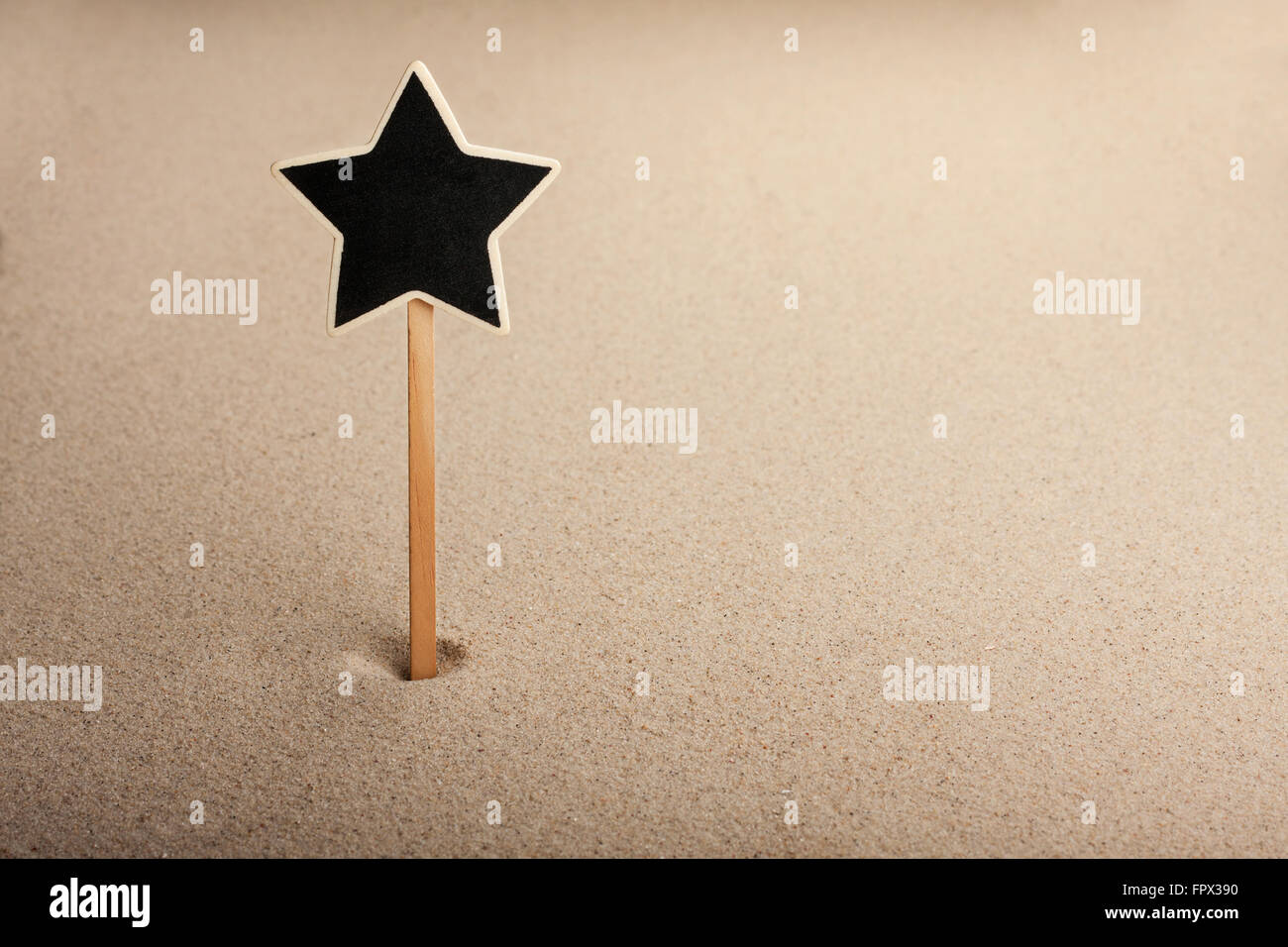 Zeiger, anzeigen-Board in der Form-Star in den Sand, kann als Hintergrund verwendet werden Stockfoto