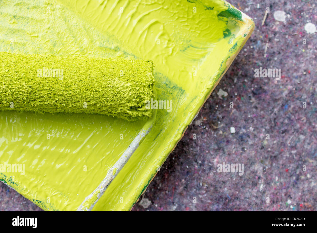 Malen Sie Walze und Farbwanne mit hellgrüner Farbe Stockfoto