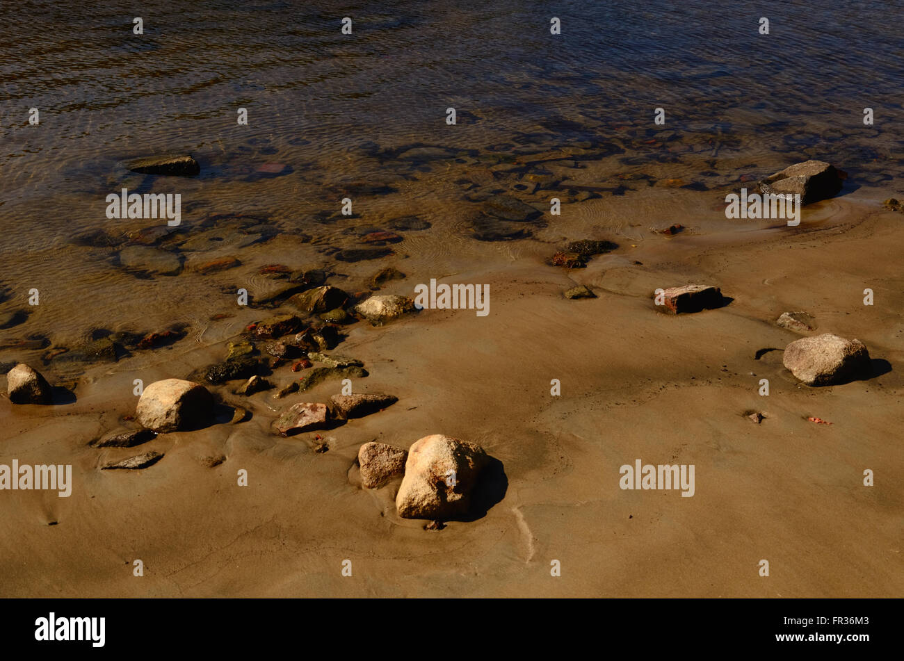 Sandy Seegrund mit Steinen im Wasser auf der Sandbank zu sehen Stockfoto