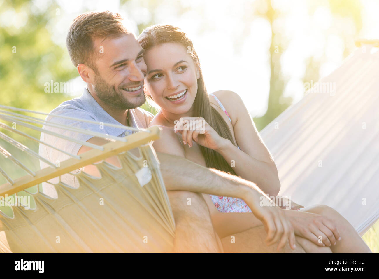 Liebevolle junge Paar lächelnd in Sommer Hängematte Stockfoto