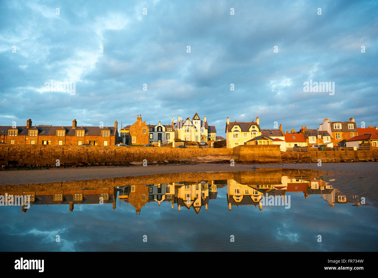 20.03.2016, geht die Sonne auf einer Häuserzeile spiegelt sich in dem Wasser bei Elie, eine Küstenstadt in der East Neuk of Fife, Schottland. Stockfoto