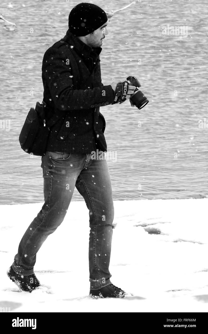 BAKU, Aserbaidschan - 31. Januar 2104 Fotograf auf Baku Bulvar im Schnee, in der Hauptstadt Aserbaidschans, in schwarz und weiß Stockfoto