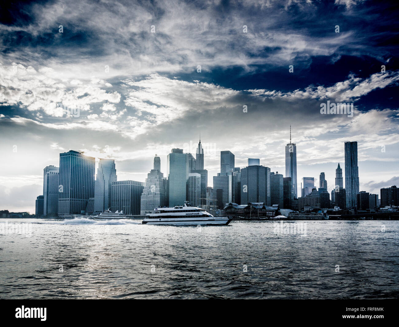 Boot am East River mit Lower Manhattan Skyline im Hintergrund, New York City, USA. Stockfoto