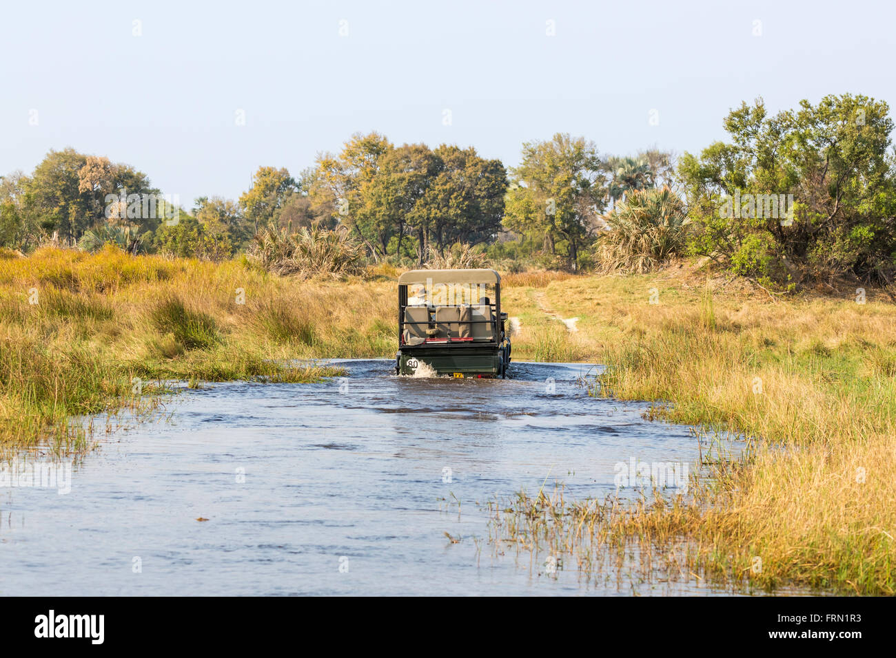 Safari 4wd Jeep Überquerung eines Flusses ford, Sandibe Camp Moremi Game Reserve, Okavango Delta, Botswana, Südafrika Stockfoto