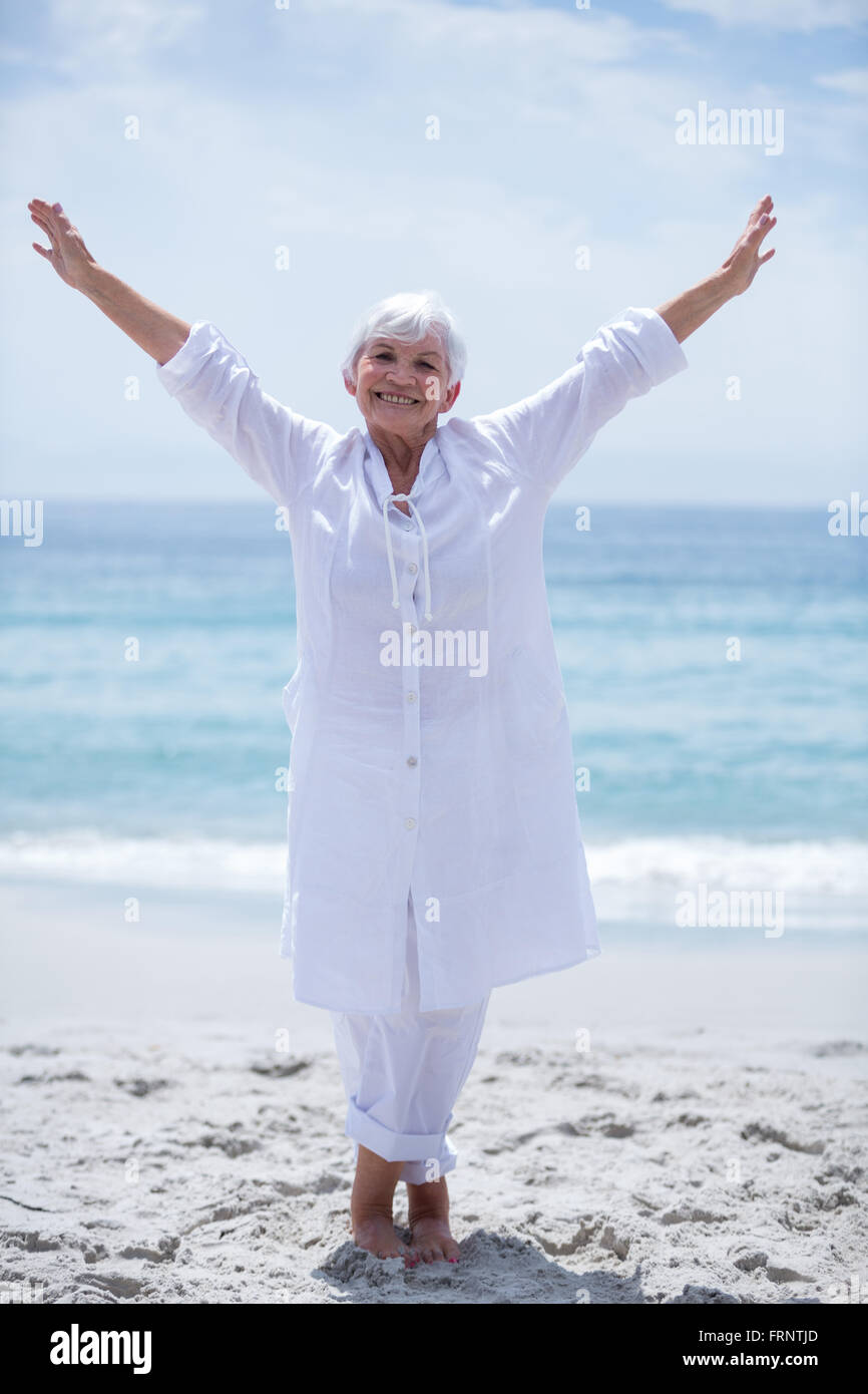 Fröhliche senior Frau mit Arme ausgestreckt auf See Ufer Stockfoto