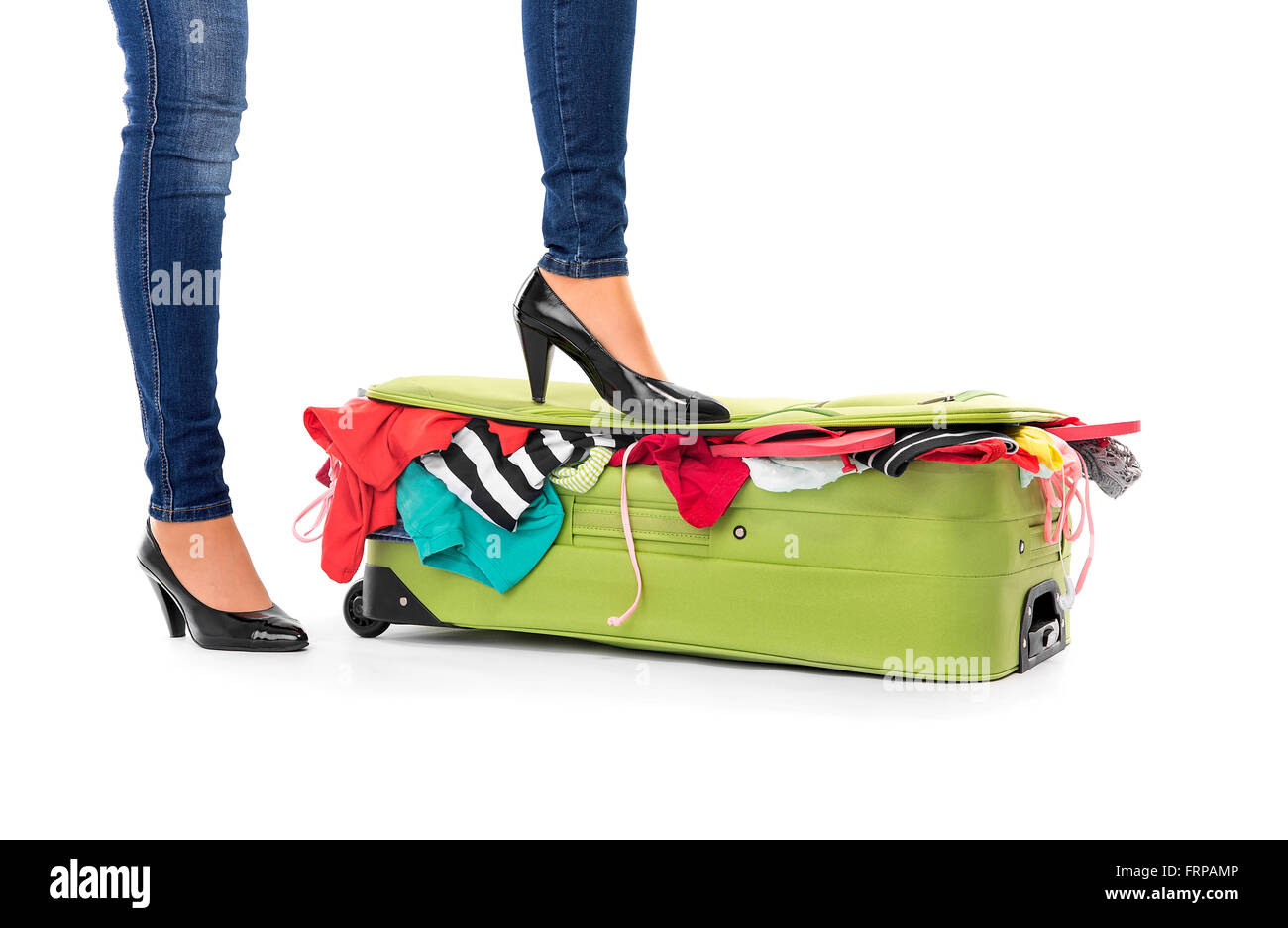 Weibliche Füße in Schuhen auf einem Koffer. Weißen Hintergrund. Stockfoto