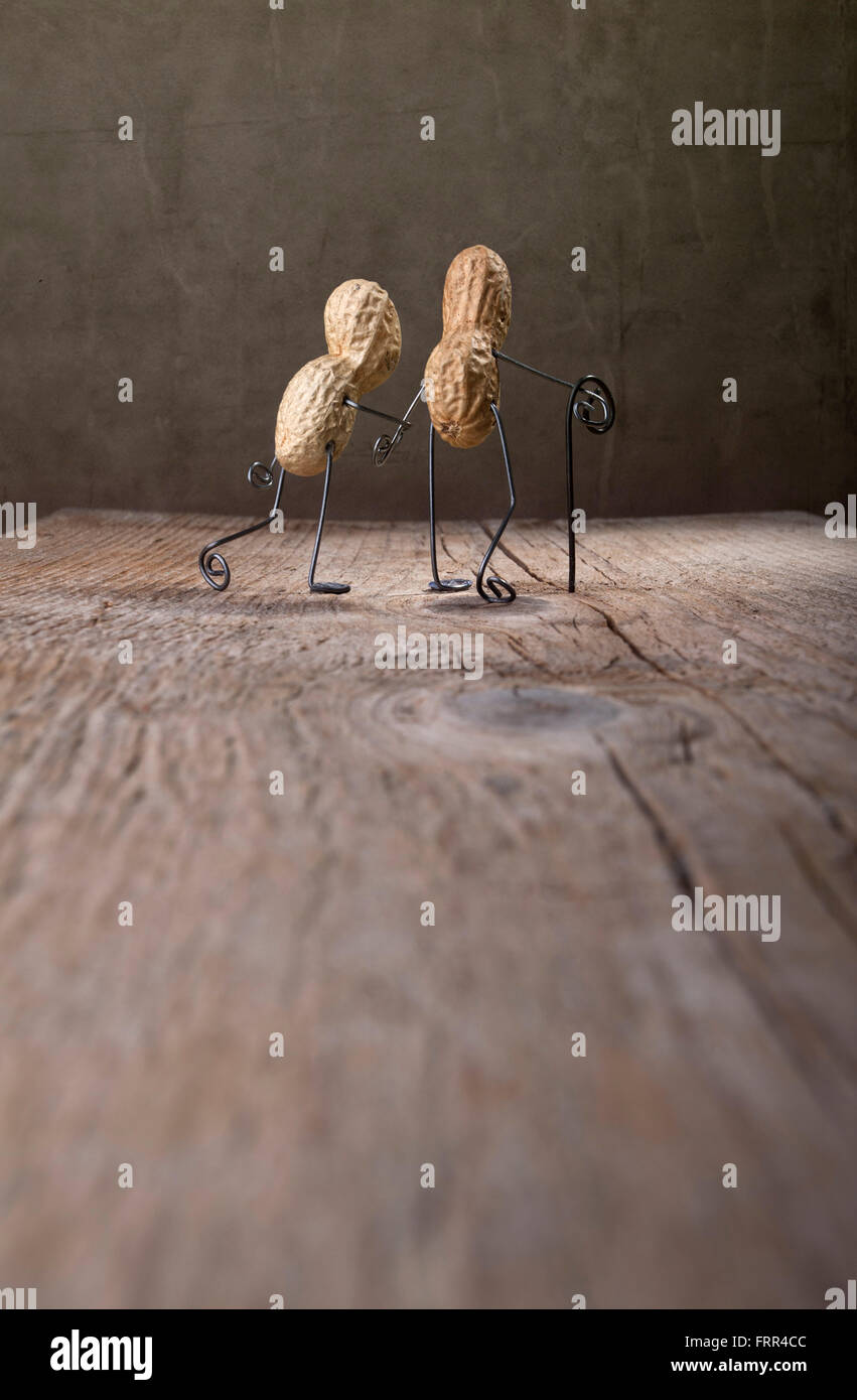 Einfache Dinge - Miniatur mit dem alten Paar gehen zusammen mit Erdnüssen und Draht Stockfoto