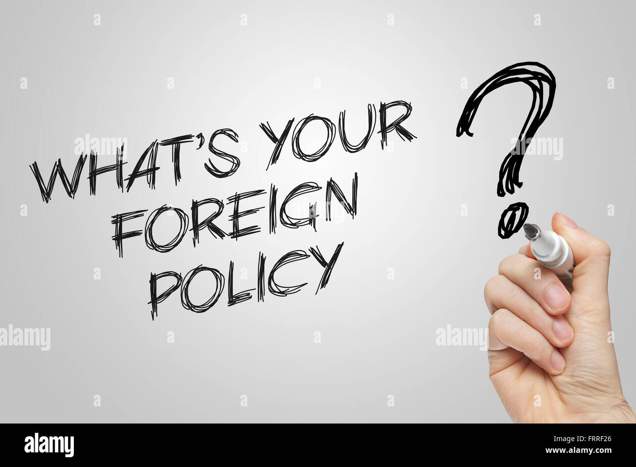 Handschrift, was Ihre Außenpolitik auf grauem Hintergrund ist Stockfoto