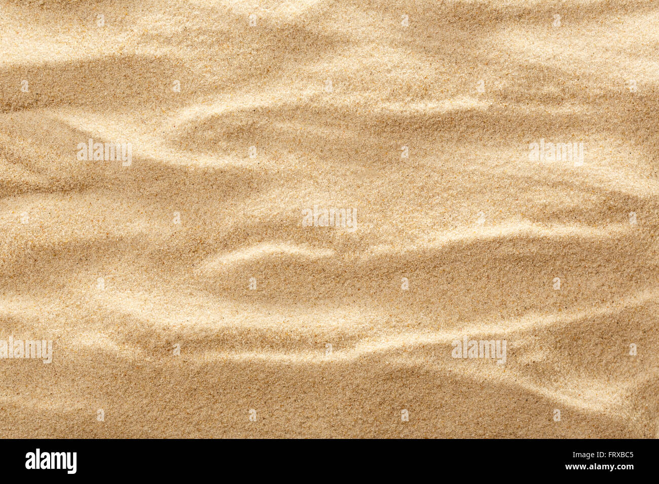 Wellenförmige Muster Strand Sand als Hintergrund Stockfoto