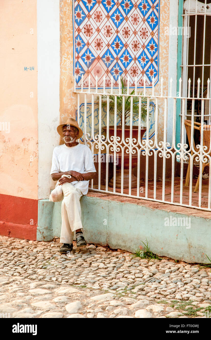 ein Mann mit Zigarre sitzt auf der Straße. Kuba, Trinidad. Stockfoto