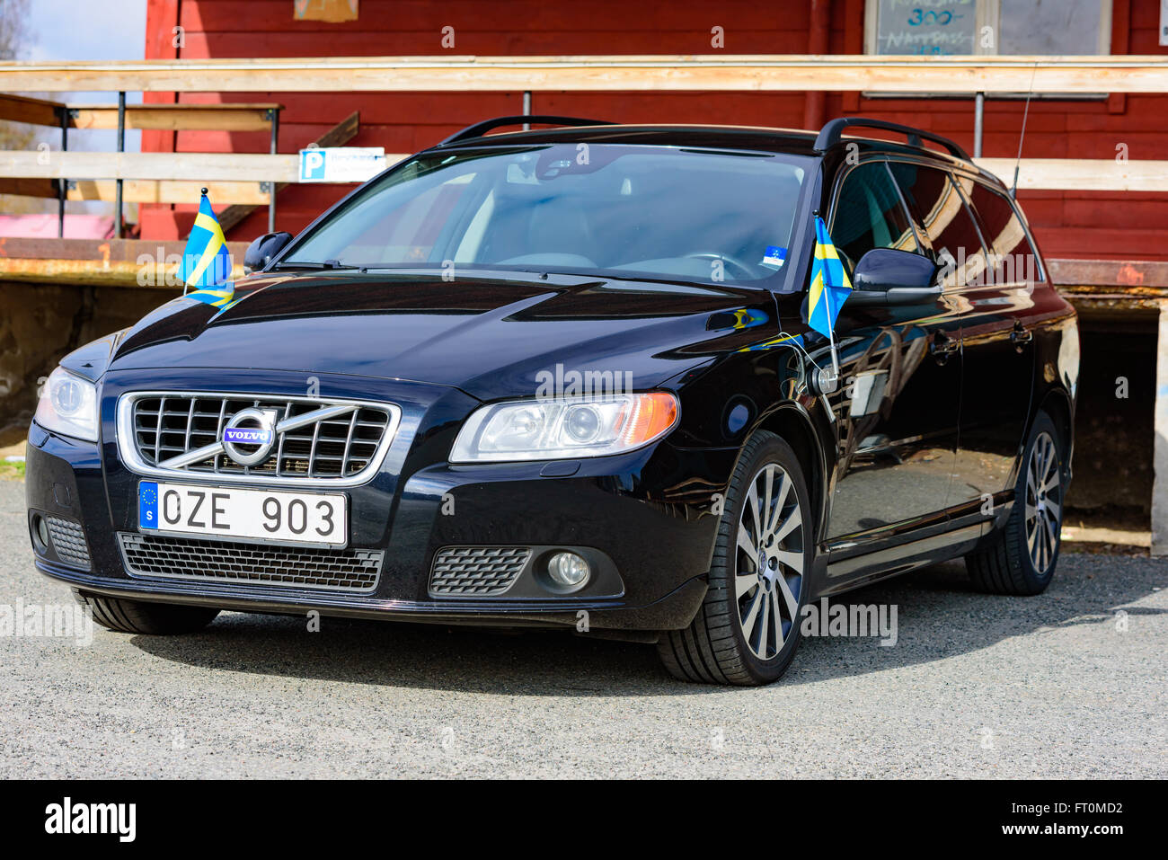 Kristianstad, Schweden - 20. März 2016: Ein schwarzer 2012 Volvo V70 mit zwei schwedischen Flaggen auf seinen Seiten montiert. Auto gesehen, von der her Stockfoto