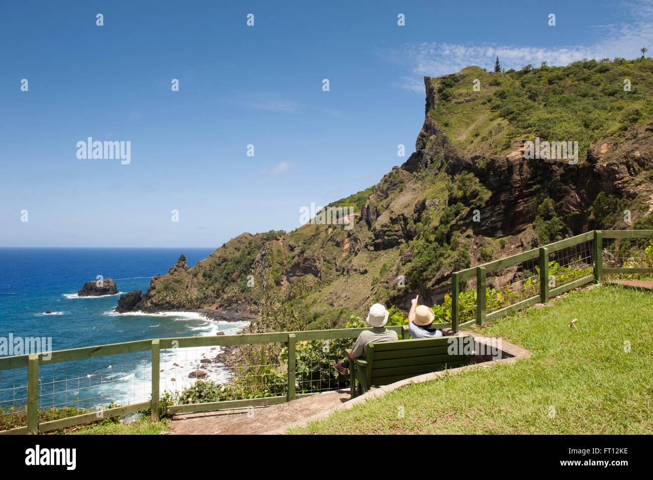 Ein paar auf einer Bank sitzen und bewundern Sie die Küste, Pitcairn, Pitcairn Group of Islands, British Overseas Territory, South Pacific Stockfoto