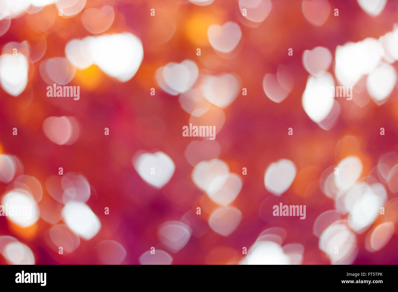 Bokeh Herz Form hellen Hintergrund Pink und Orange gefärbt Stockfoto