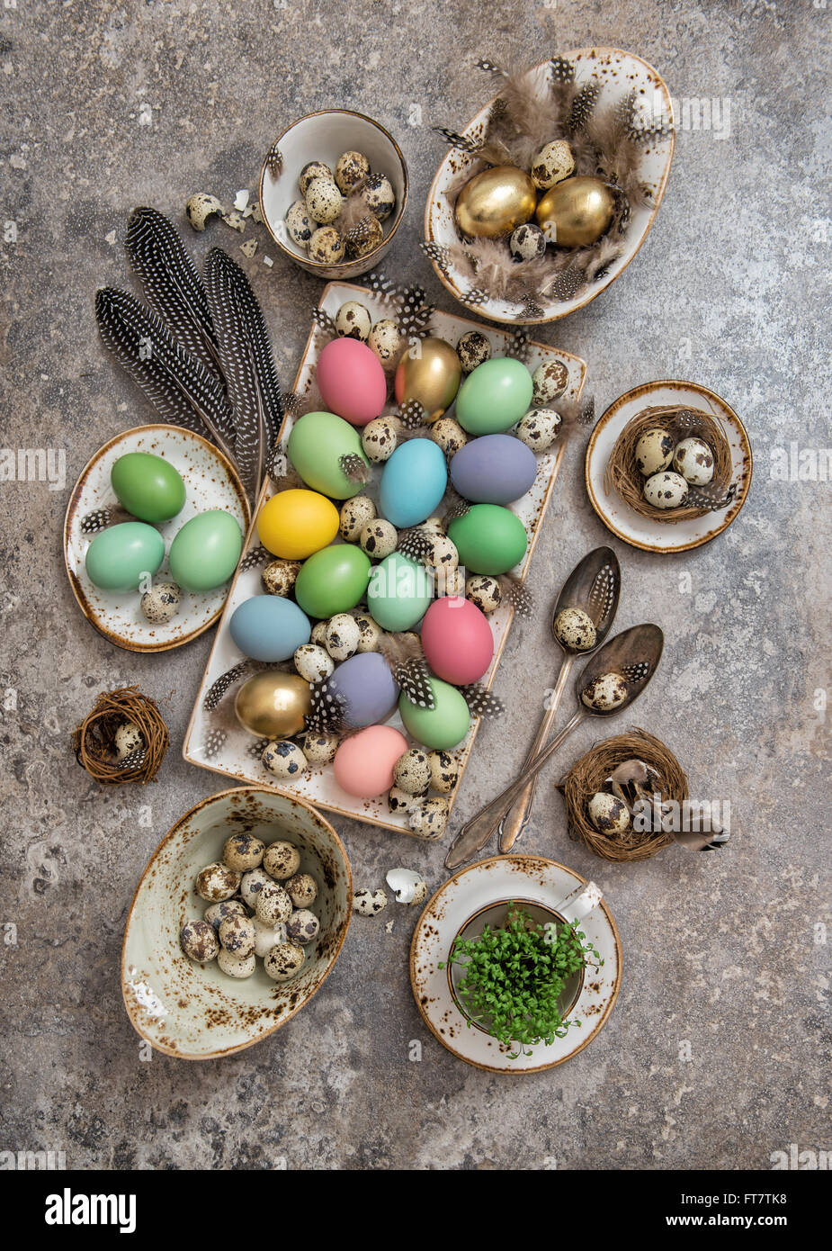 Oster-Deko mit farbigen Eiern und Federn der Vögel. Boho Style Urlaub Hintergrund Stockfoto