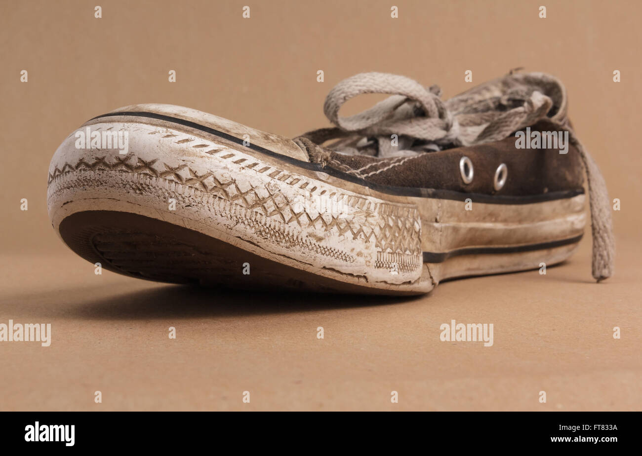 Unter der Fußsohle eine alte schmutzige Sneaker nachschlagen Stockfoto