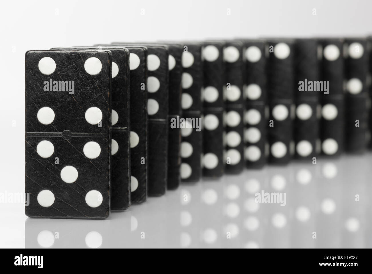 Zusammensetzung der ständigen schwarzen Domino-Steinen mit weißen Punkten Stockfoto