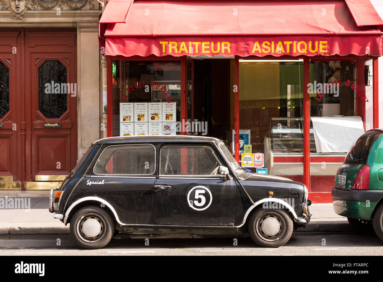 Typisch Paris Straßenszenen: ein kleine, Retro-Stil Auto geparkt vor der ein chinesisches Restaurant Stockfoto
