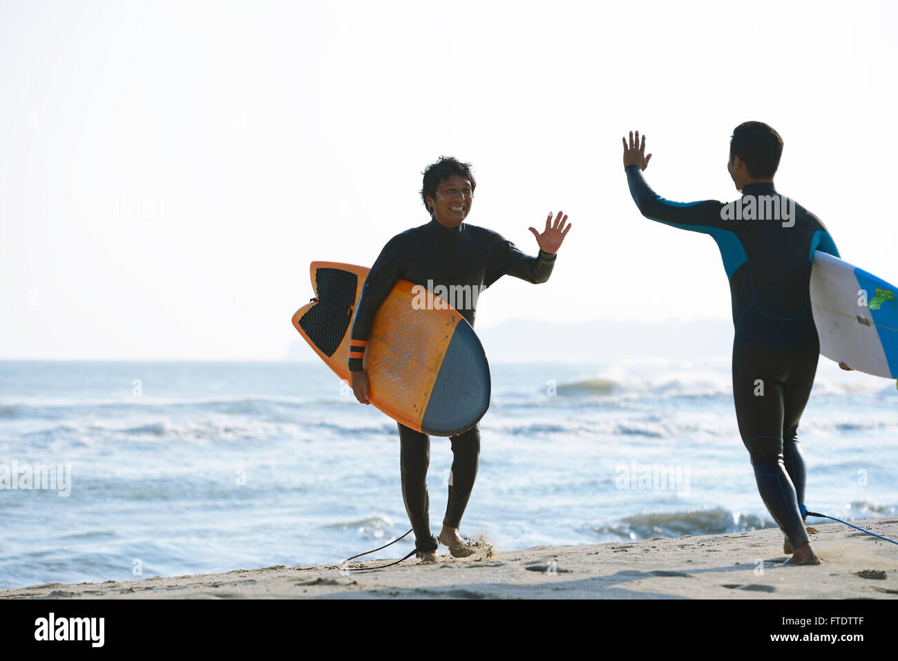 Japanische Surfer am Strand Stockfoto