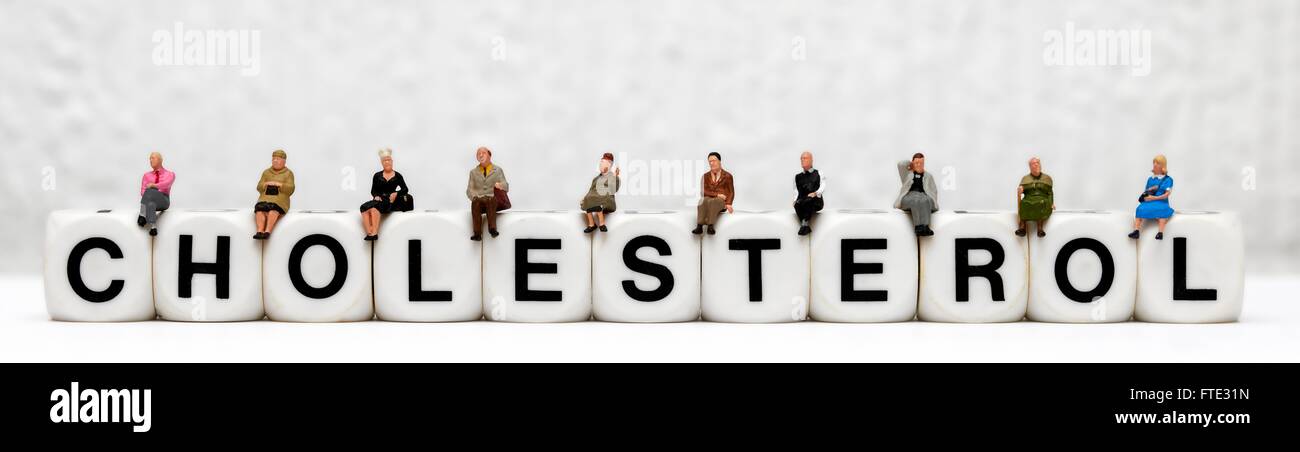 Miniatur-Figuren sitzen oben auf das Wort Cholesterin Stockfoto