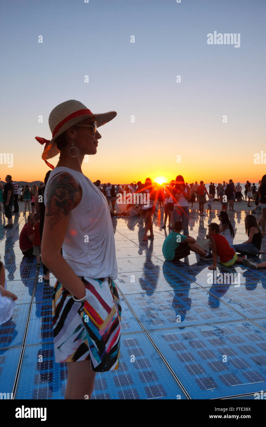 Weibliche beobachten Sonnenuntergang in Zadar. Grüße an Sonne Denkmal. Stockfoto