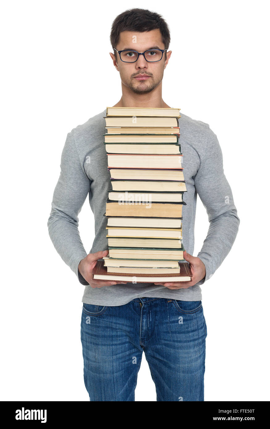 Junger Mann mit einem Stapel Bücher in Händen, isoliert auf weiss Stockfoto
