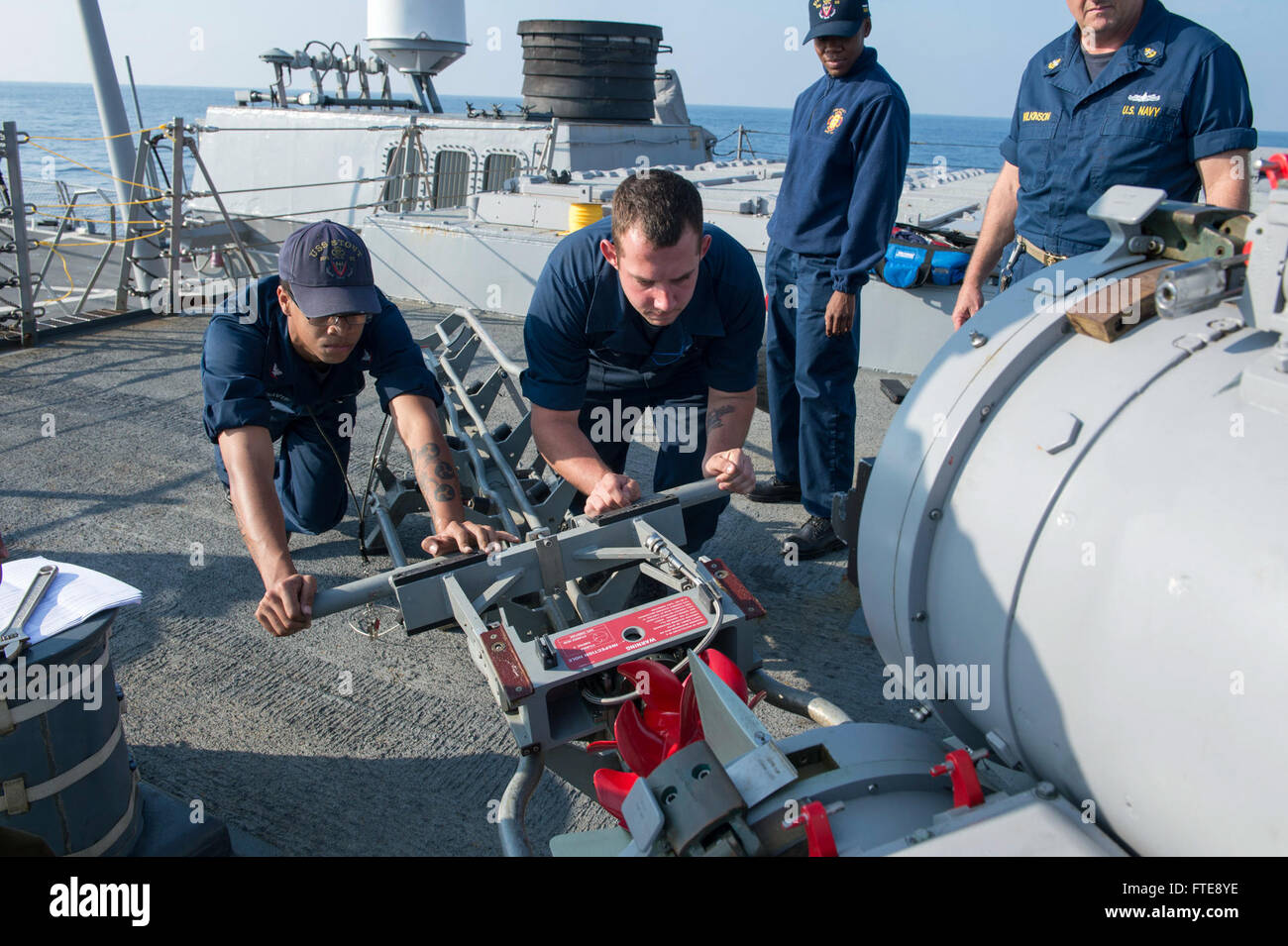 Mittelmeer (2. Januar 2014) - Gunner es Mate 2. Klasse Christian Davis, links, und des Kanoniers Mate Seemann Evan Buege schieben ein Mk 46 Torpedos in einer Oberfläche Schiff Torpedorohr nach Test brennen Luft Schnecken an Bord der Arleigh-Burke-Klasse geführte Flugkörper Zerstörer USS Stout (DDG-55).  Stout, Gridley in Norfolk, Virginia, ist auf eine geplante Bereitstellung unterstützen maritimer Sicherheitsoperationen und Sicherheitsbemühungen Zusammenarbeit Theater in den USA 6. Flotte Einsatzgebiet. (Foto: U.S. Navy Mass Communication Specialist 2. Klasse Amanda R. Gray/freigegeben) Stockfoto