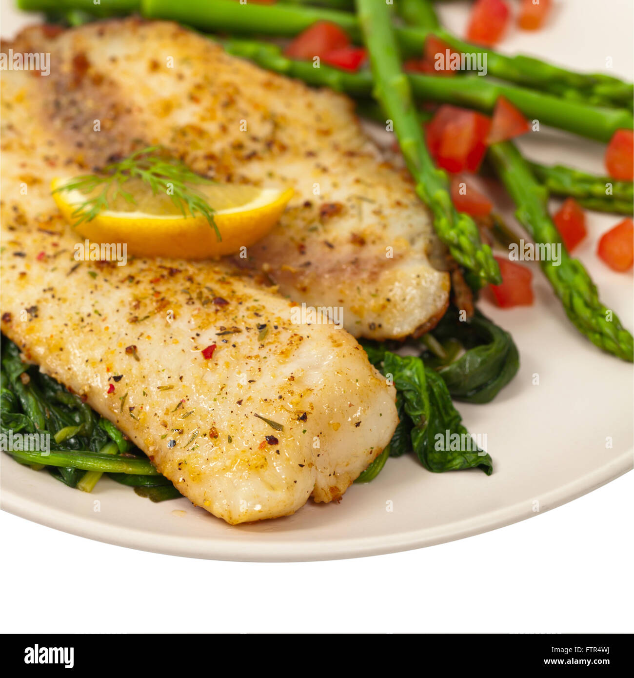 Gebackenes Fischfilet mit sautierten Spinat Stockfoto