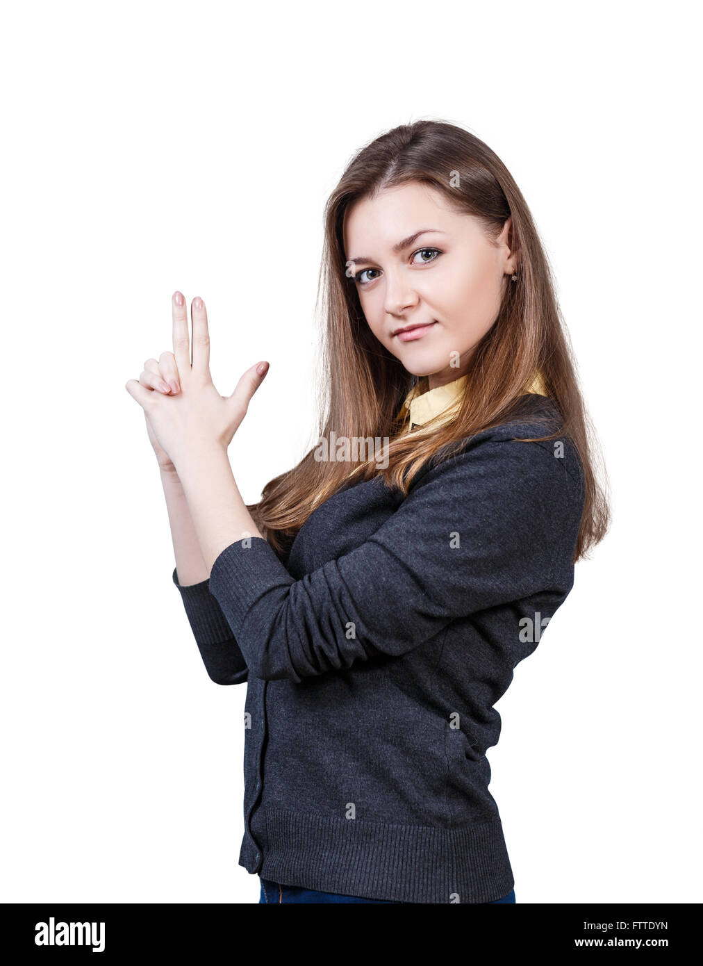 Junge schöne Frau mit Pistole Geste Stockfoto