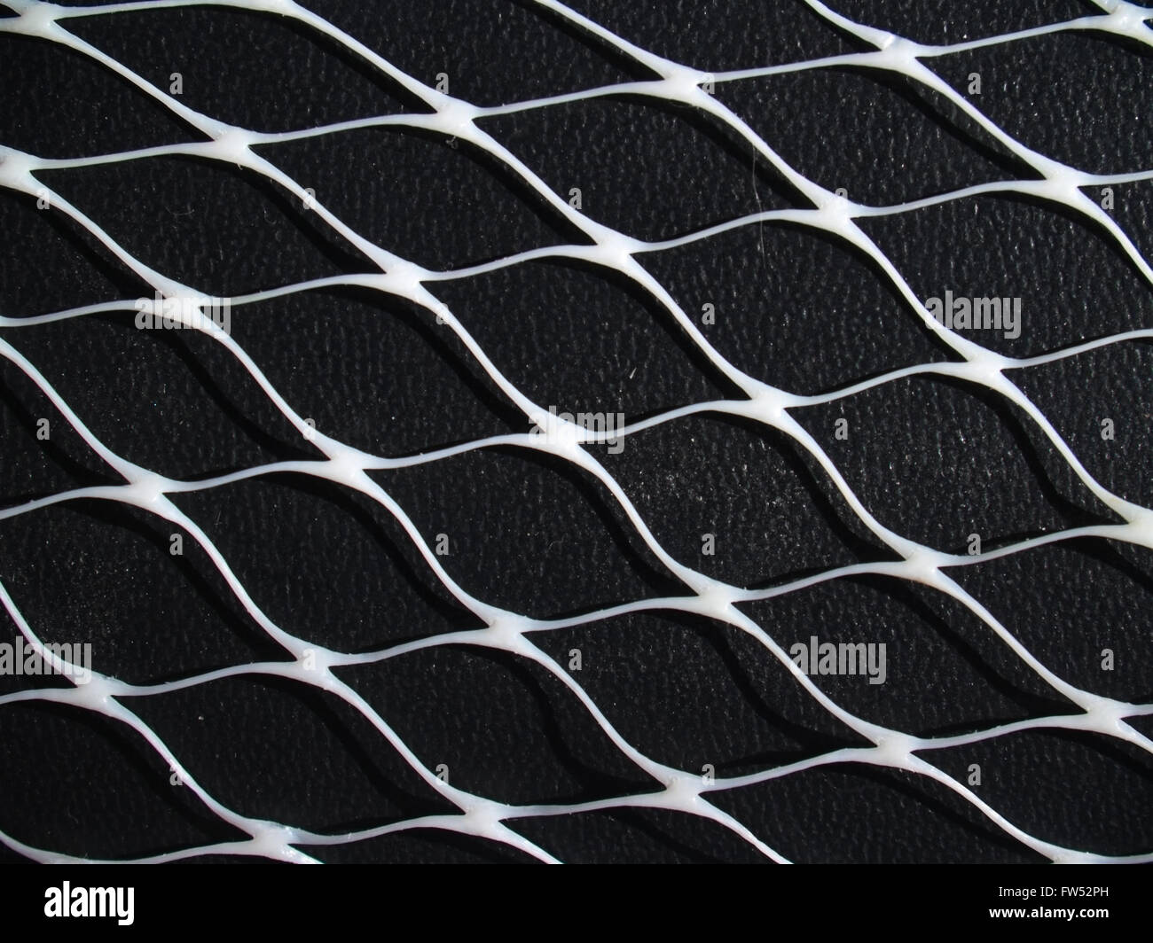 Weiß net auf schwarzem Lederoberfläche Stockfoto