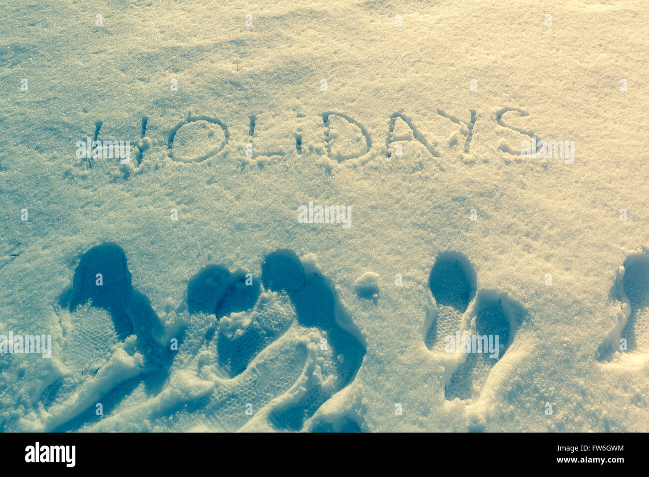 Geschriebene Wörter Urlaub auf einem Schneefeld Stockfoto