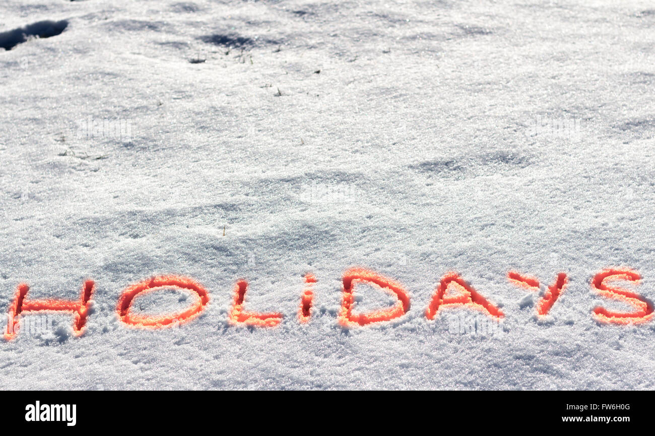 Geschriebene Wörter Urlaub auf einem Schneefeld Stockfoto