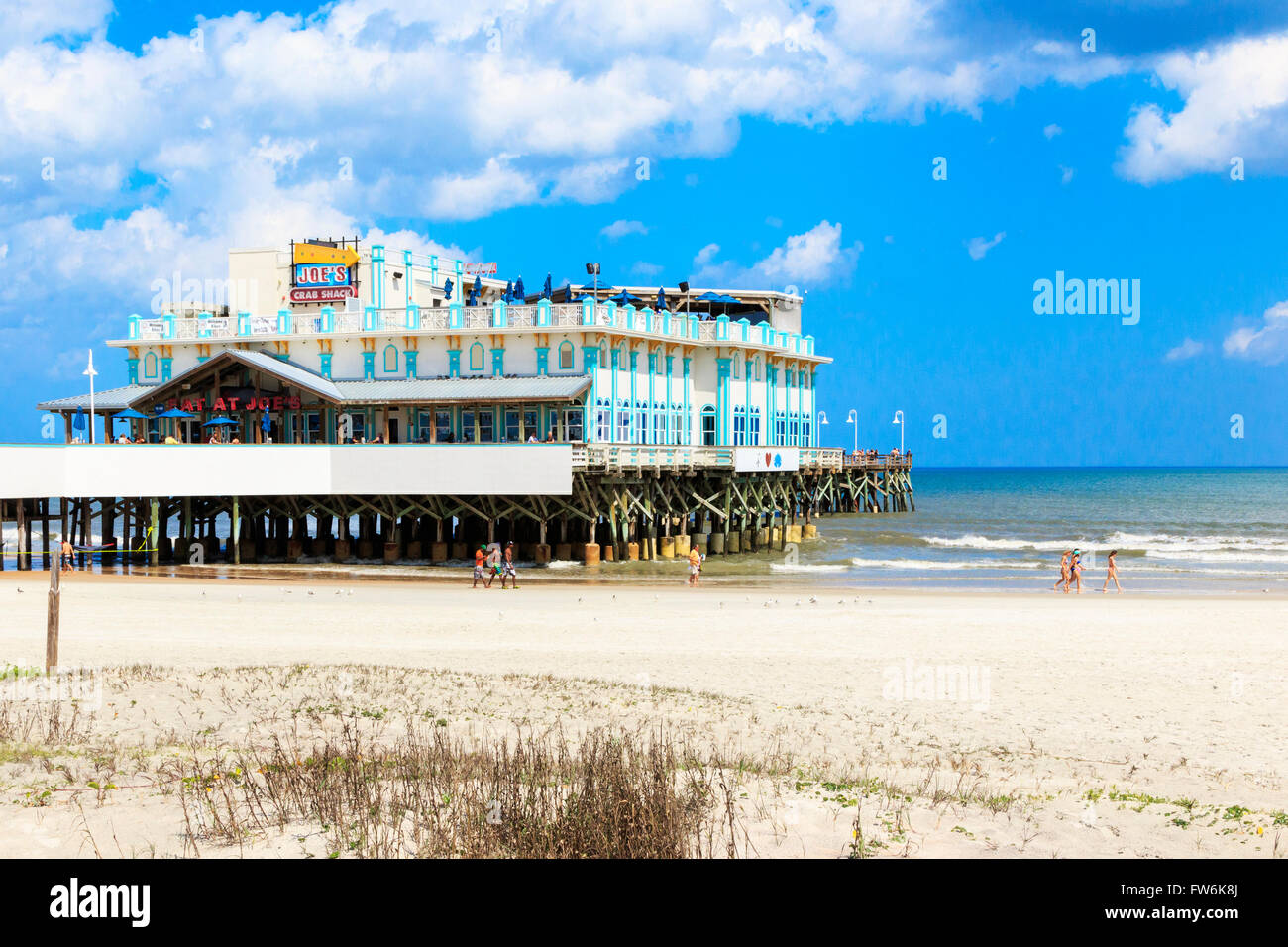 Daytona Beach mit Touristen und Sonnenanbeter, Florida, Amerika, USA und dem traditionellen Pier im Hintergrund. Stockfoto