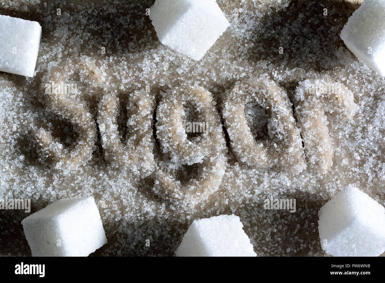 Zuckerwürfel auf zuckerhaltige Gebäck Schriftzug Stockfoto