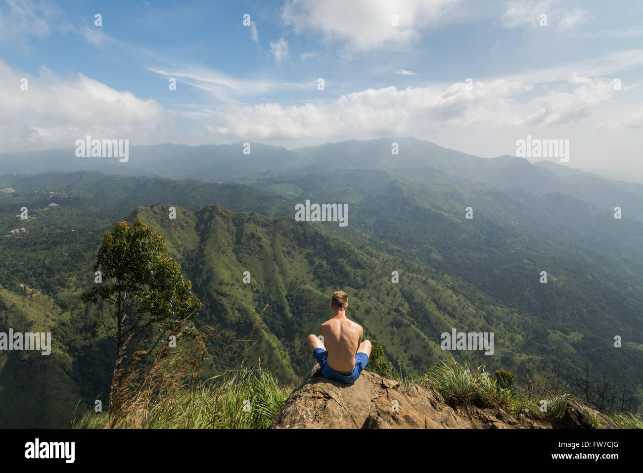 Mann sitzt am Rand des kleinen Adam es Peak Stockfoto