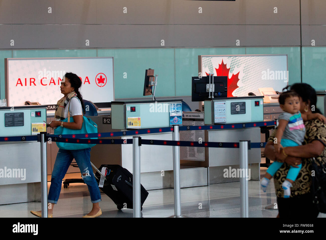 Eine Frau geht durch eine leere Air Canada Check-in Schalter im Terminal 1 am Pearson International Airport in Toronto, Ontario. Stockfoto