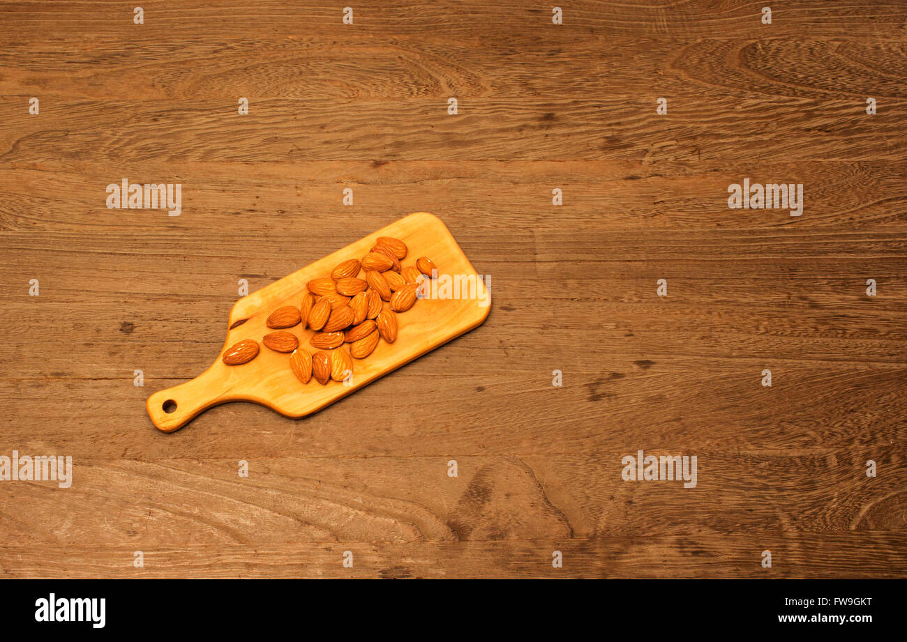 Rohe Mandeln Holz Platte auf Holztisch Stockfoto