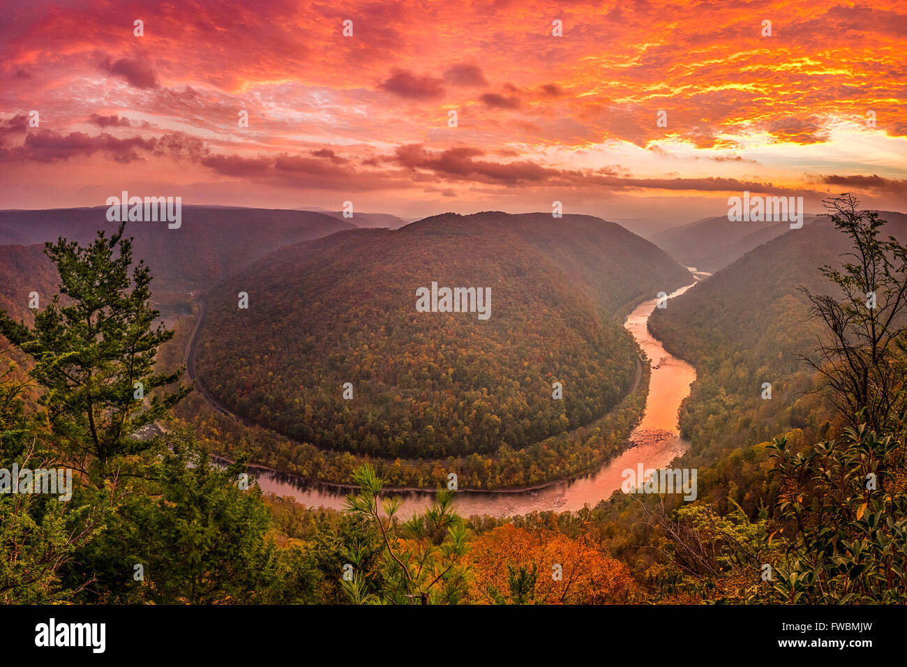 Die Morgendämmerung Sonne aufgeht, erwachen die Herbstfarben der im Grandview, WV, wo der Fluss schlängelt sich um die Kurve in den Hügeln. Stockfoto