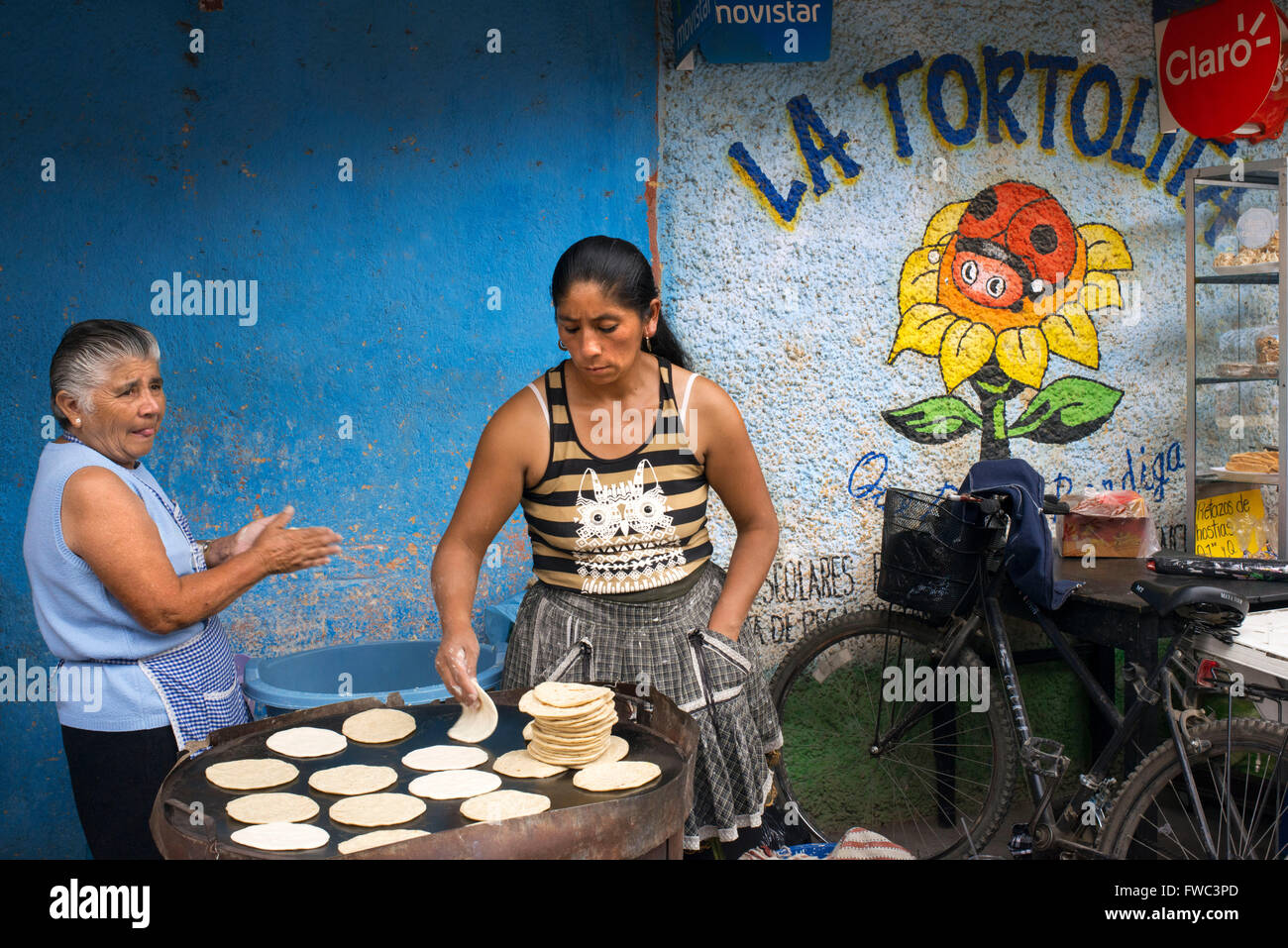 Maya-Frauen Backen Tortillas in den Straßen von Antigua, Guatemala, Mittelamerika. La Tortolita. Stockfoto