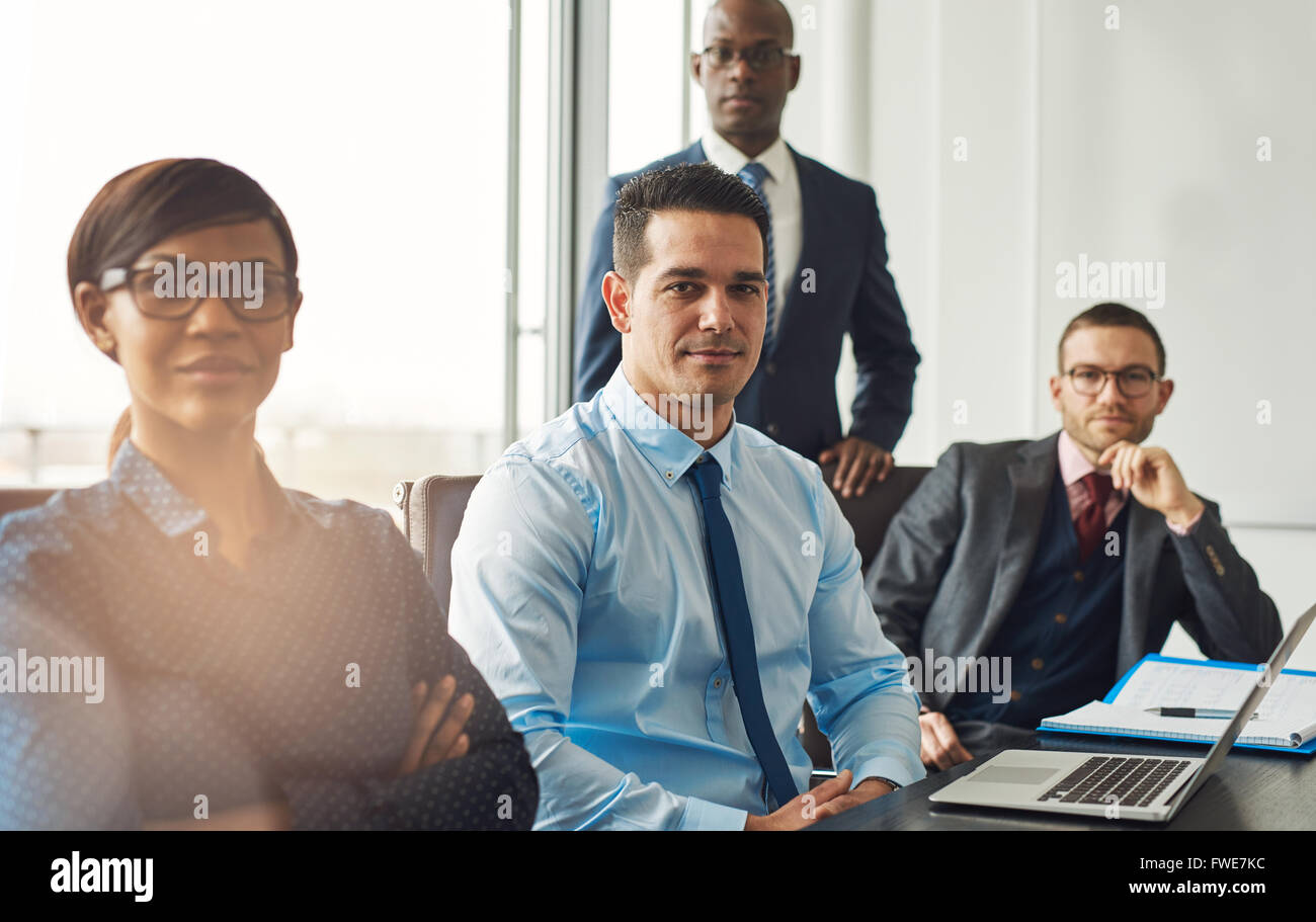 Lächelt zuversichtlich multirassische Business-Team sitzen an einem Tisch in einem Konferenzraum im Büro machen unternehmerische Entscheidungen Stockfoto