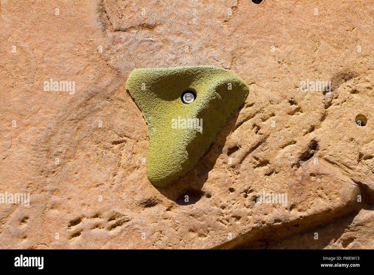 Eine Nahaufnahme von einem Felsen, die Kletterwand und die Hand hält, die von Kletterern verwendet werden, um die Struktur zu skalieren. Stockfoto