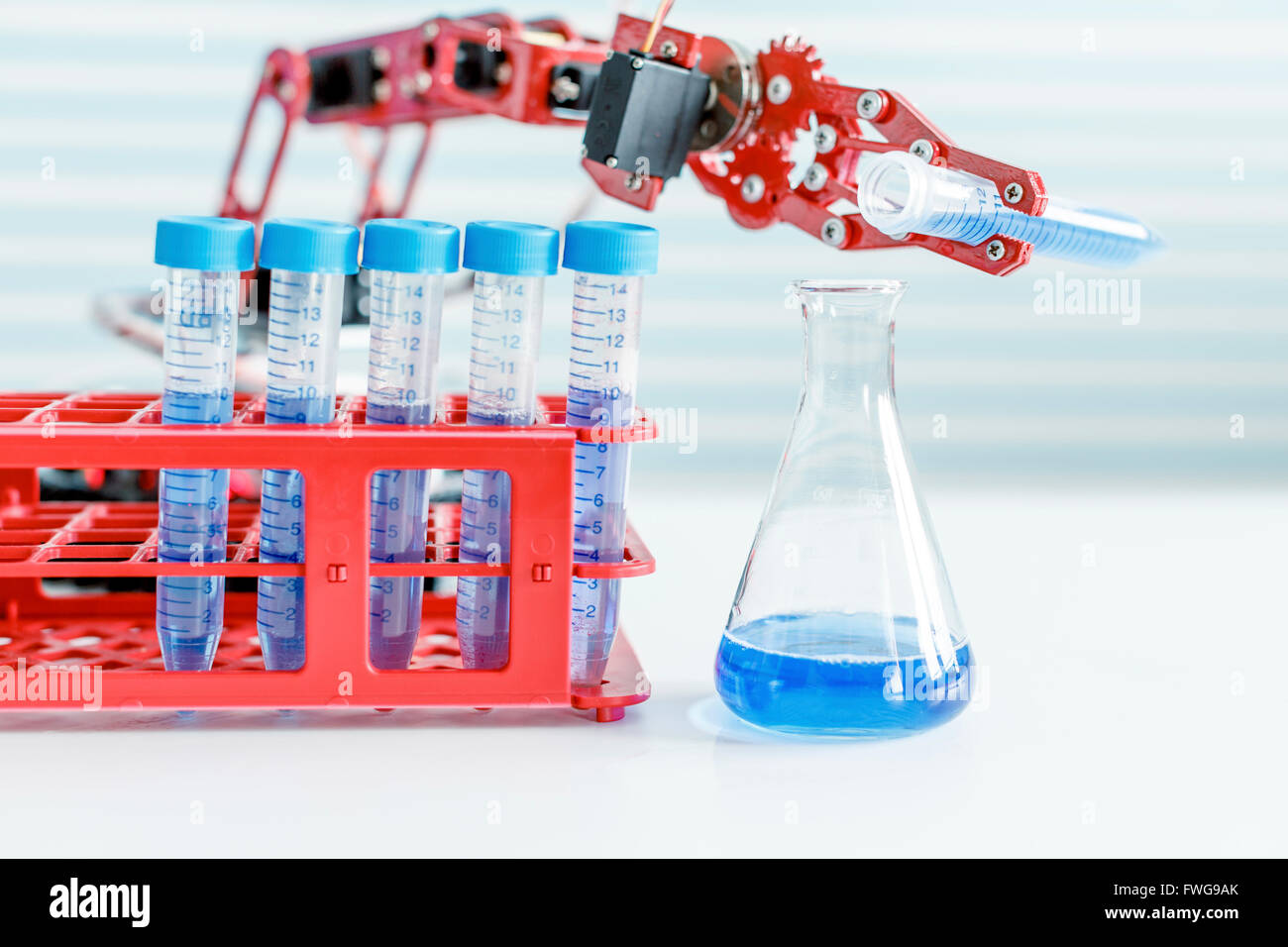 Roboterarm Chemikalie in Flasche gießen. Stockfoto